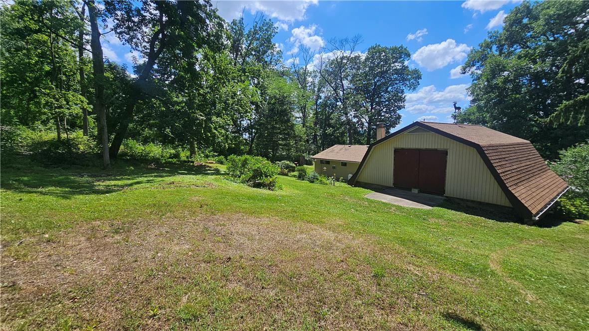 2529 Ringhoffer Road Hellertown, PA 18055 - Photo 29 of 33 A spacious backyard with mature trees surrounds this charming barn-style structure.
