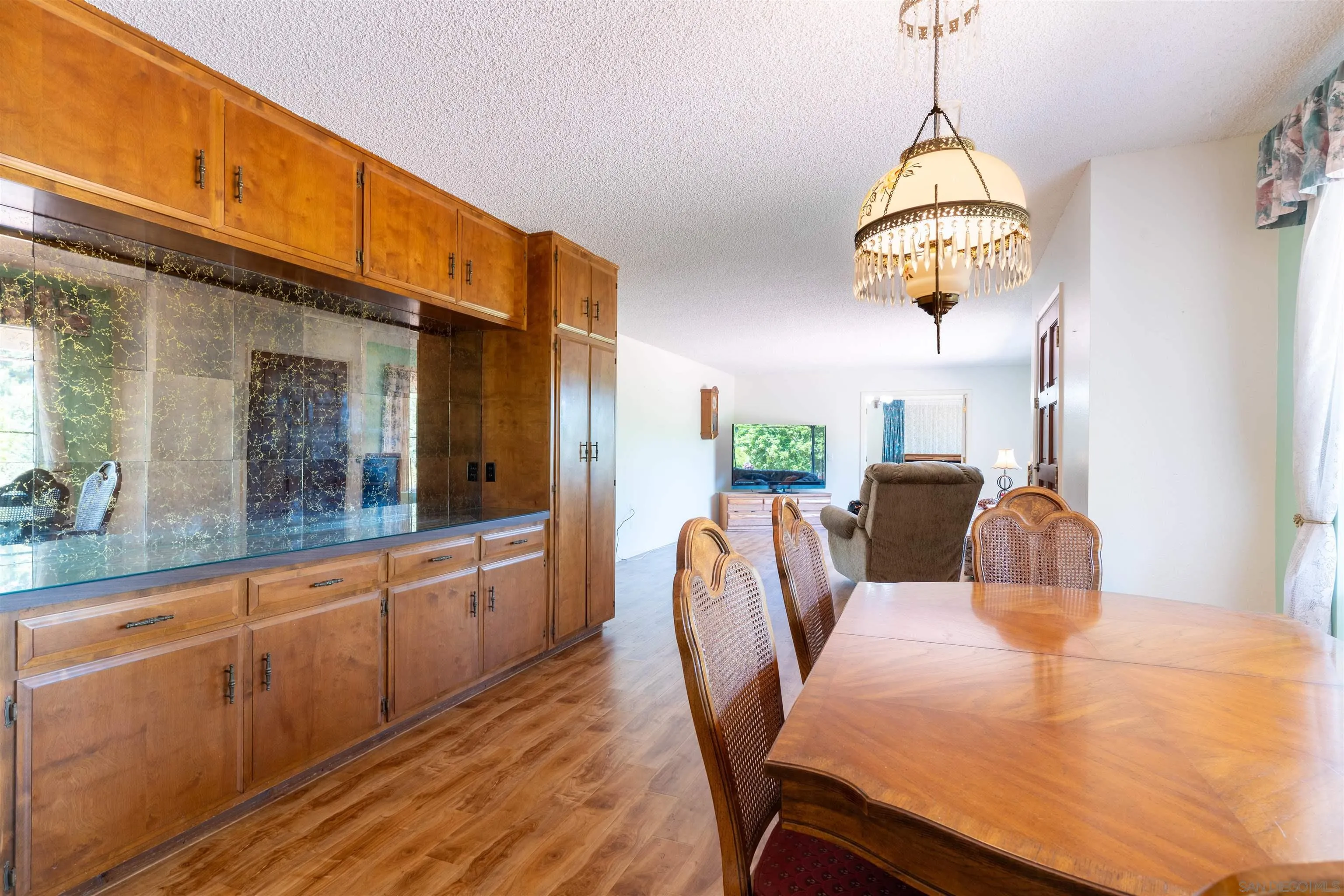 1345 Green Canyon Road Fallbrook, CA 92028 - Photo 8 of 31 a dining room with furniture a chandelier and window