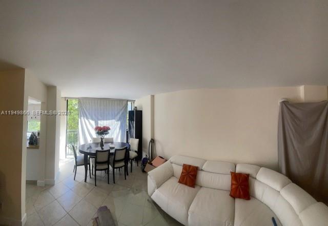 16919 North Bay Road, Unit 414 Sunny Isles Beach, FL 33160 - Photo 2 of 7 a living room with furniture and a large window