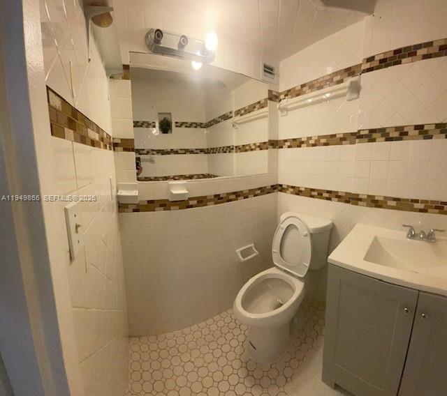 16919 North Bay Road, Unit 414 Sunny Isles Beach, FL 33160 - Photo 4 of 7 a bathroom with a sink a toilet and shower