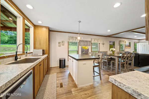 a kitchen with stainless steel appliances granite countertop a sink stove and cabinets