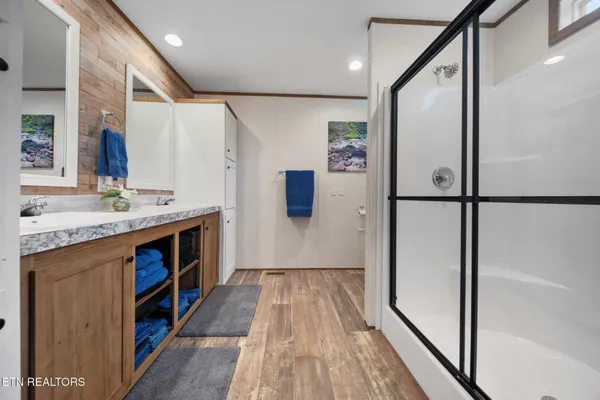 a bathroom with a granite countertop sink toilet and shower