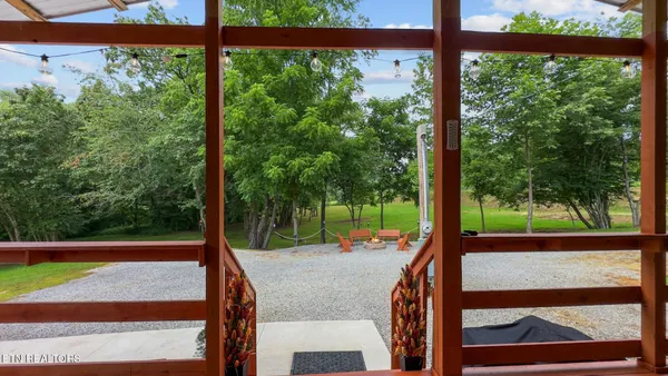 a view of a house with backyard and sitting area