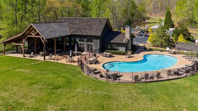 a view of a house with backyard and sitting area