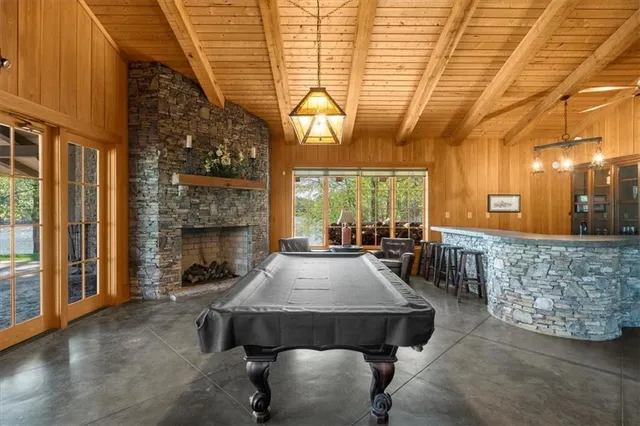 a living room with furniture a fireplace and a table