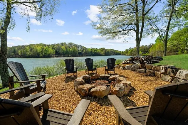 a view of a lake with couches chairs