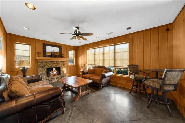 a living room with furniture fireplace and a large window