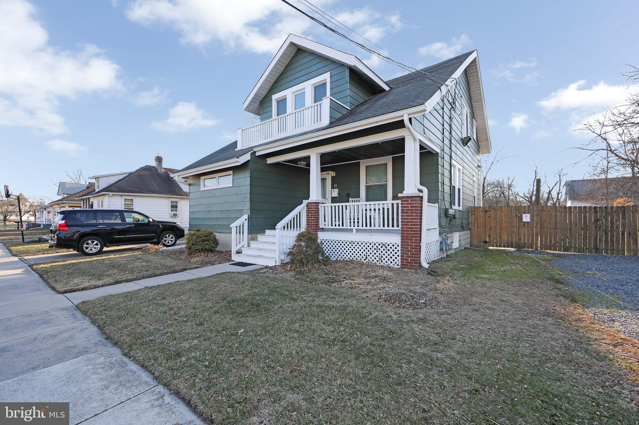 a car parked in front of white house