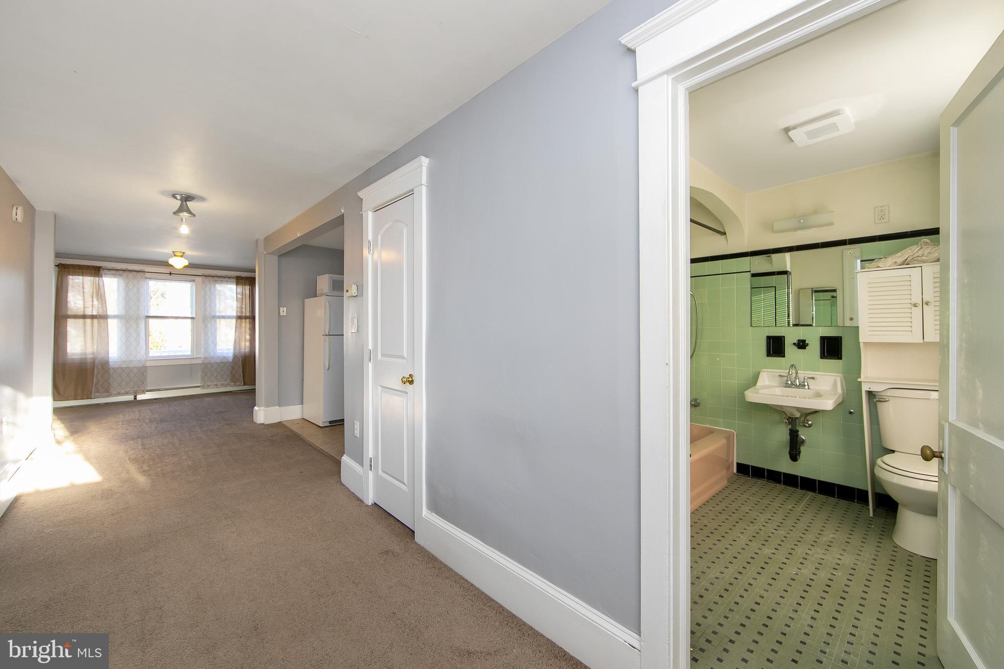 11-13 Church Street, Unit B Glassboro, NJ 08028 - Photo 11 of 33 a bathroom with a sink toilet and shower