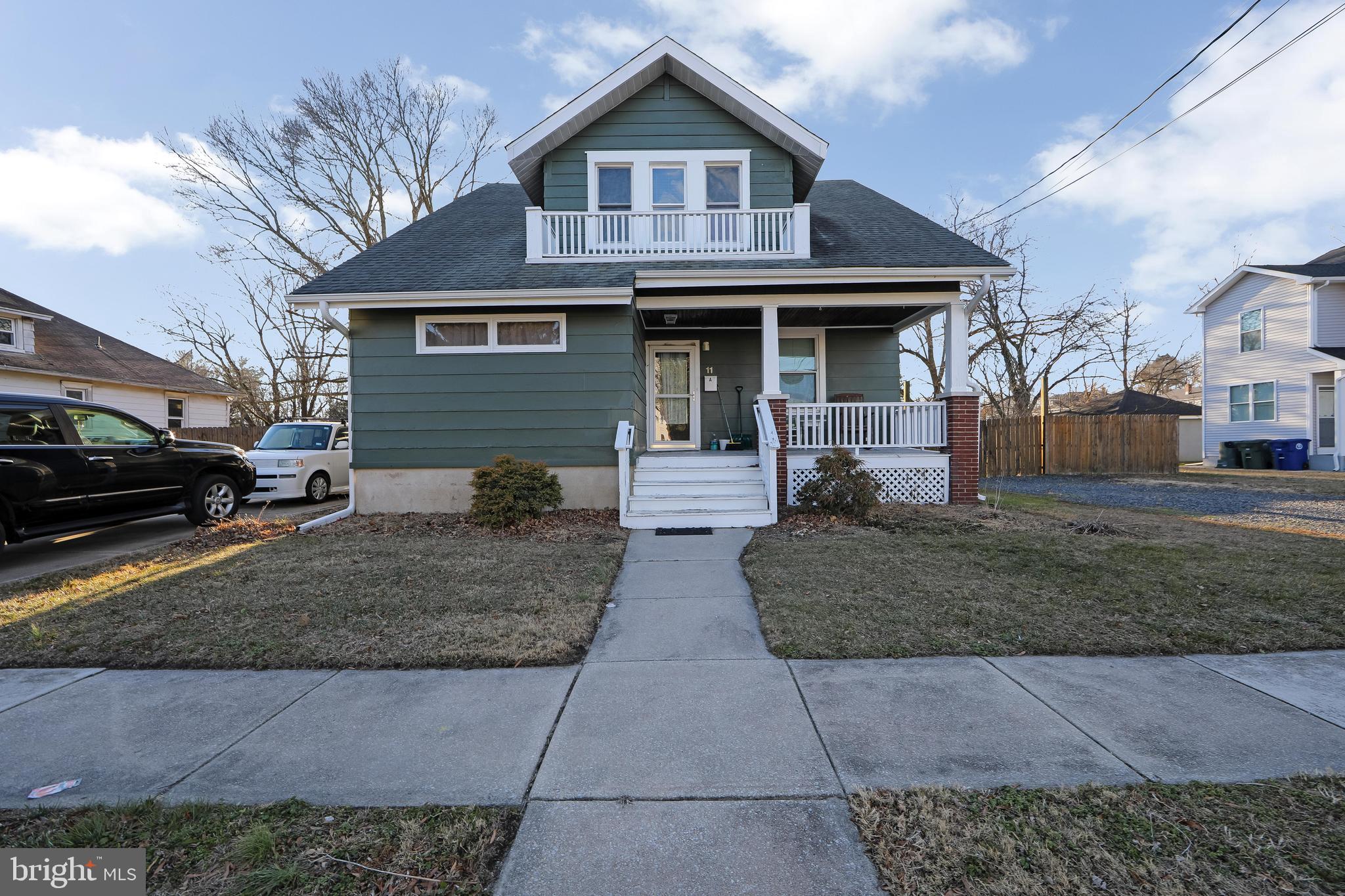 11-13 Church Street, Unit B Glassboro, NJ 08028 - Photo 2 of 33 a front view of a house with a yard and garage