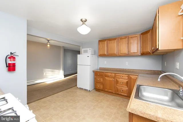 a kitchen with granite countertop a sink cabinets and window