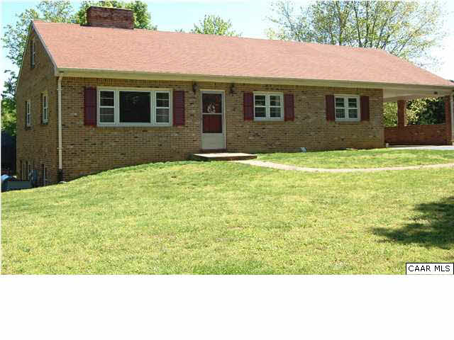 a view of a house with a backyard