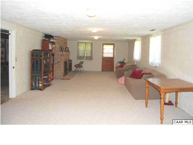 1816 Old Orchard Road Free Union, VA 22940 - Photo 13 of 16 a living room with furniture a window and a flat screen tv
