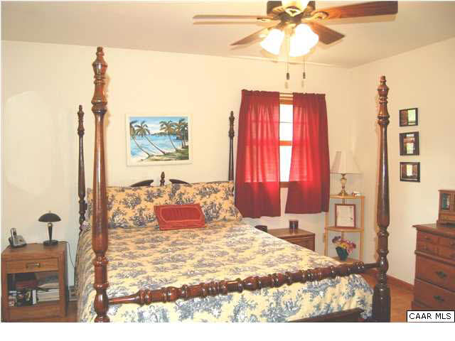 1816 Old Orchard Road Free Union, VA 22940 - Photo 10 of 16 a bedroom with a bed and a chandelier