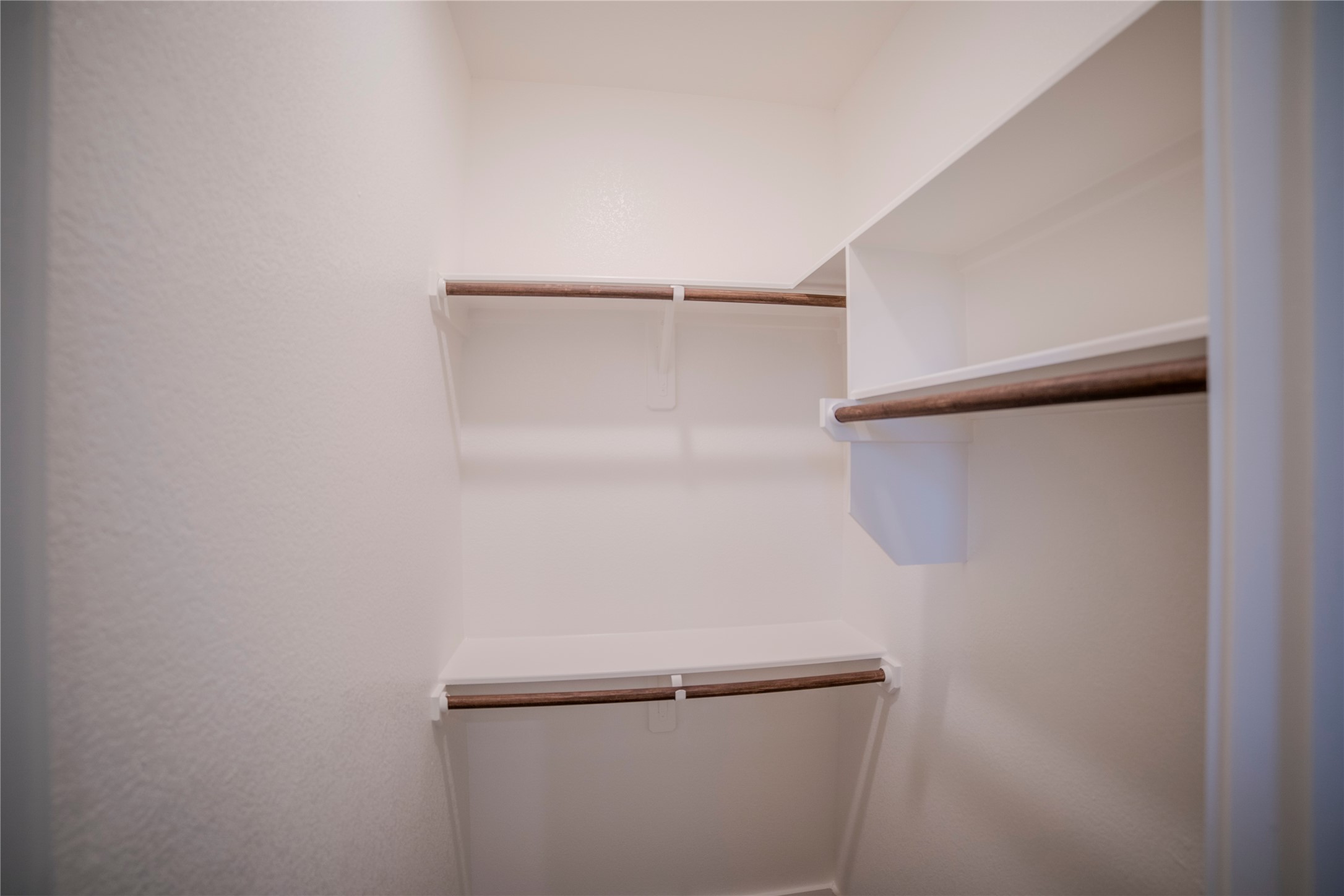 1402 Lk Rdg Drive Brenham, TX 77833 - Photo 11 of 35 a view of walk in closet with empty racks