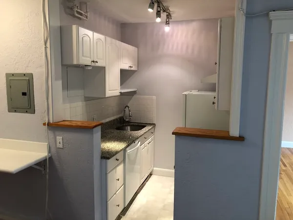 a kitchen with stainless steel appliances a stove a refrigerator and a sink