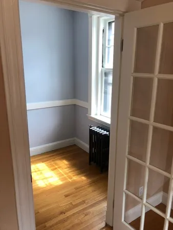 a view of a room with wooden floor