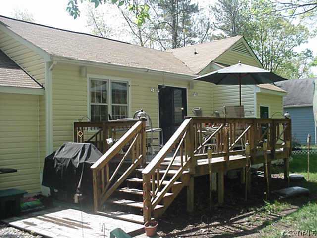 1424 Oldbury Road Midlothian, VA 23113 - Photo 2 of 6 a roof deck with table and chairs under an umbrella