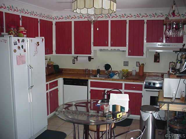 1424 Oldbury Road Midlothian, VA 23113 - Photo 4 of 6 a kitchen with stainless steel appliances granite countertop a sink refrigerator and cabinets