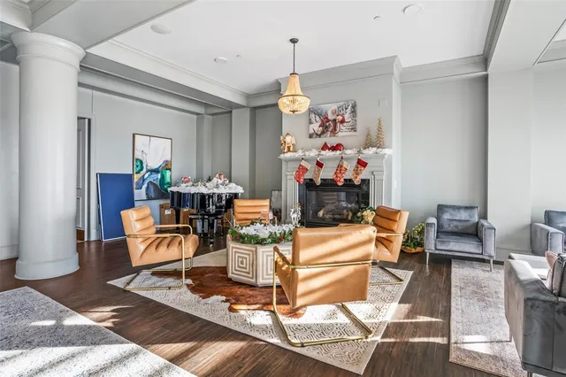 a living room with a table chairs and a chandelier