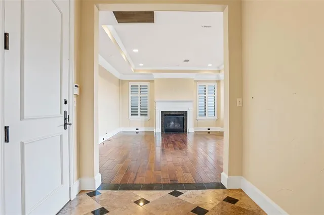 a view of a livingroom with wooden floor and a fireplace