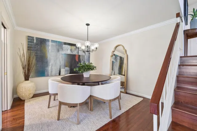 a view of a dining room with furniture and wooden floor
