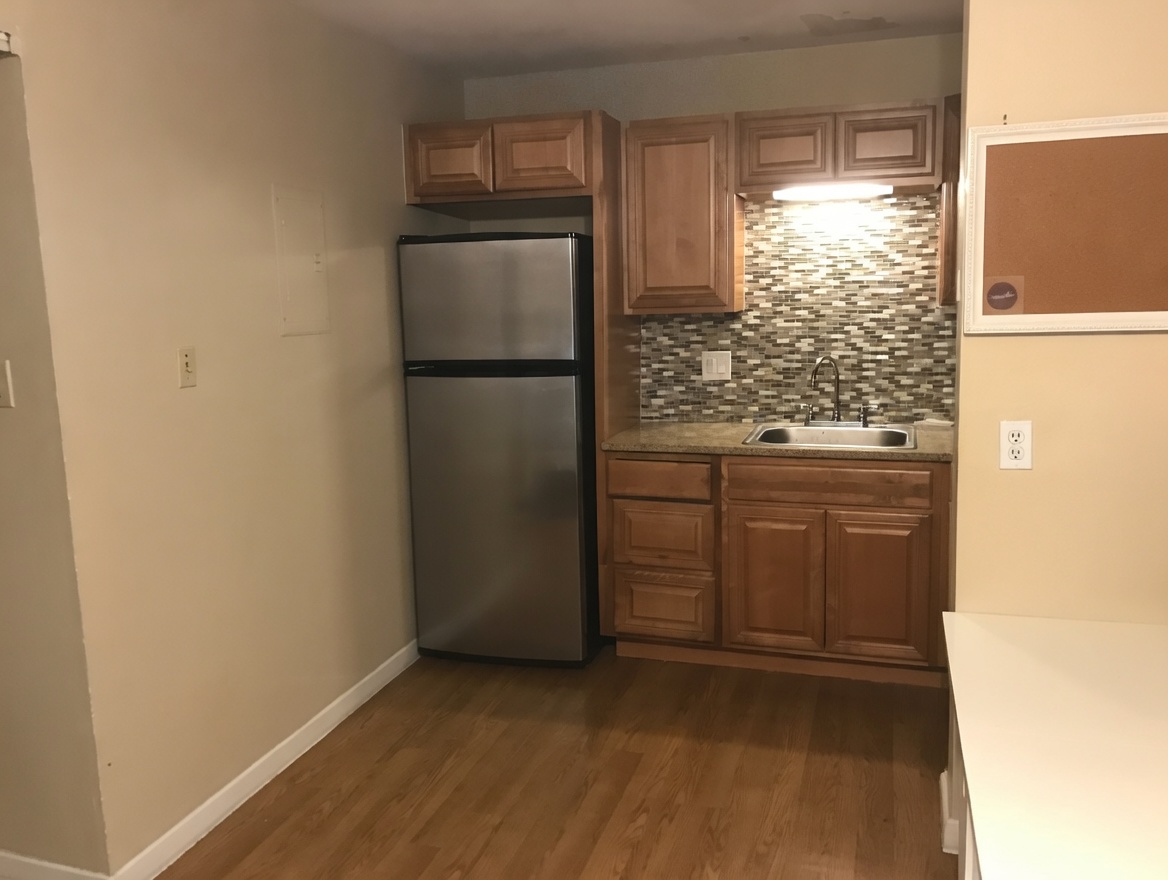 1000 West 26th Street, Unit 112 Austin, TX 78705 - Photo 3 of 14 a kitchen with a refrigerator and a stove