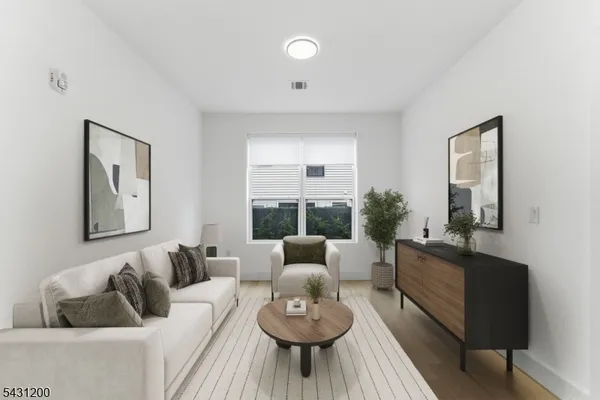 a living room with furniture and a large mirror