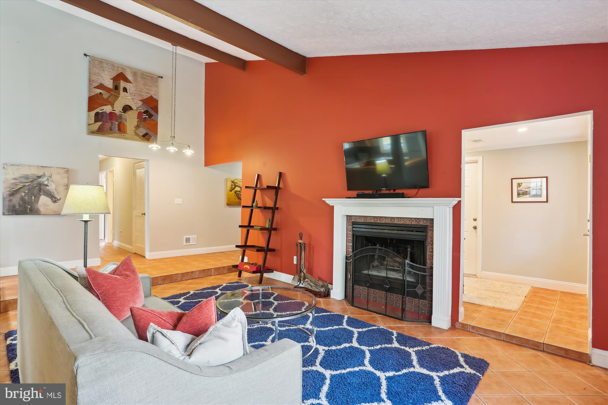 19500 Wootton Avenue Poolesville, MD 20837 - Photo 18 of 62 a living room with furniture a flat screen tv and a fireplace