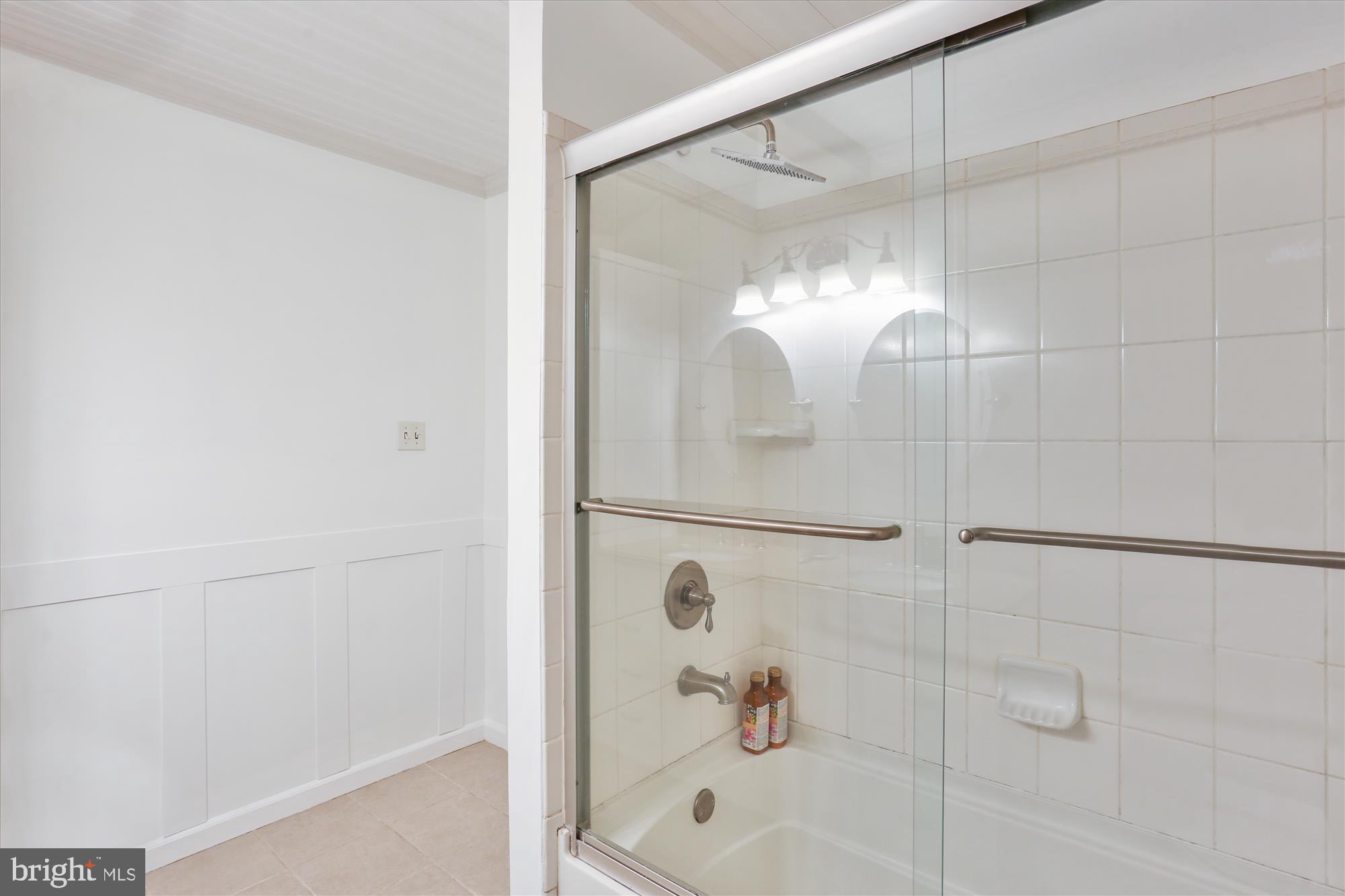 19500 Wootton Avenue Poolesville, MD 20837 - Photo 40 of 62 a bathroom with a bathtub and a shower