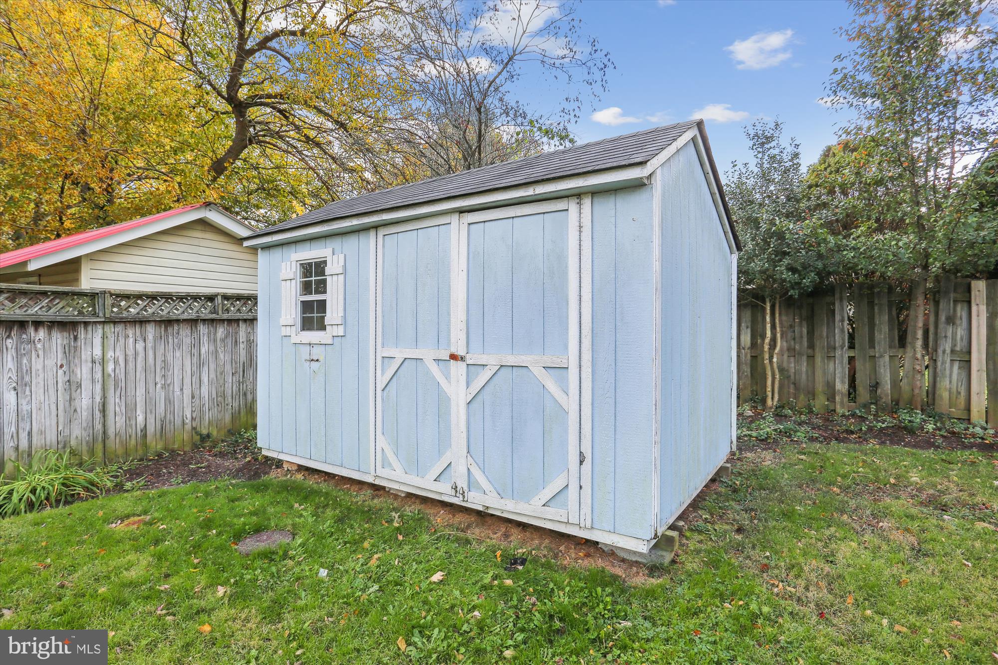 19500 Wootton Avenue Poolesville, MD 20837 - Photo 60 of 62 a backyard of a house with lots of green space and wooden fence