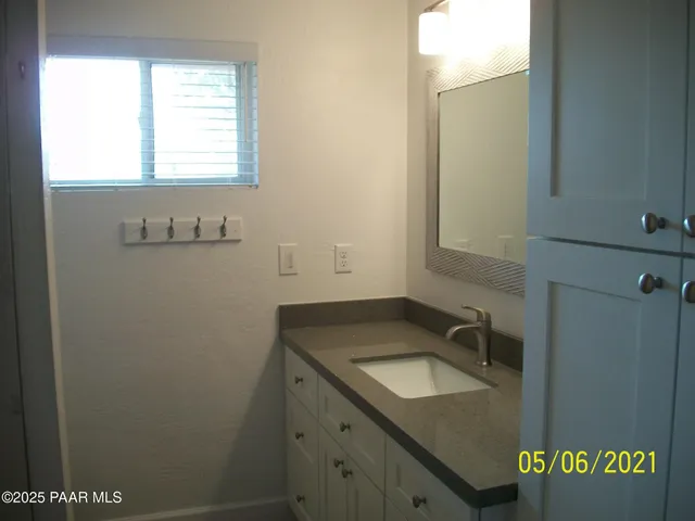 a bathroom with a granite countertop sink and a vanity