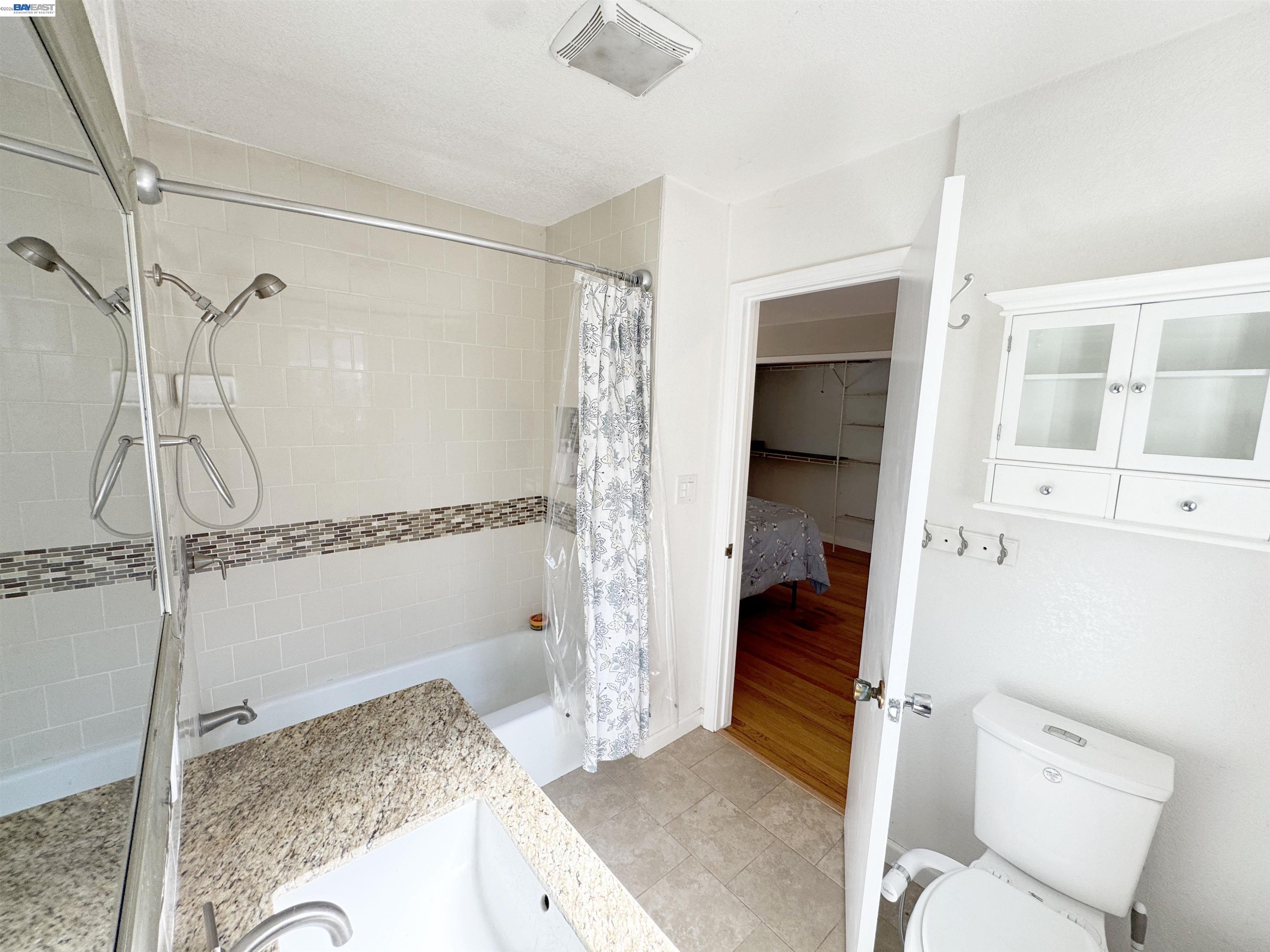 17121 Laurel Road Los Gatos, CA 95033 - Photo 15 of 43 a bathroom with a granite countertop sink and a shower