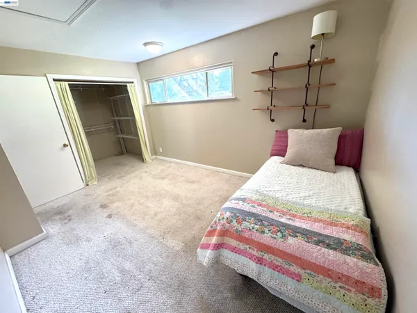 a bedroom with a bed and a mirror