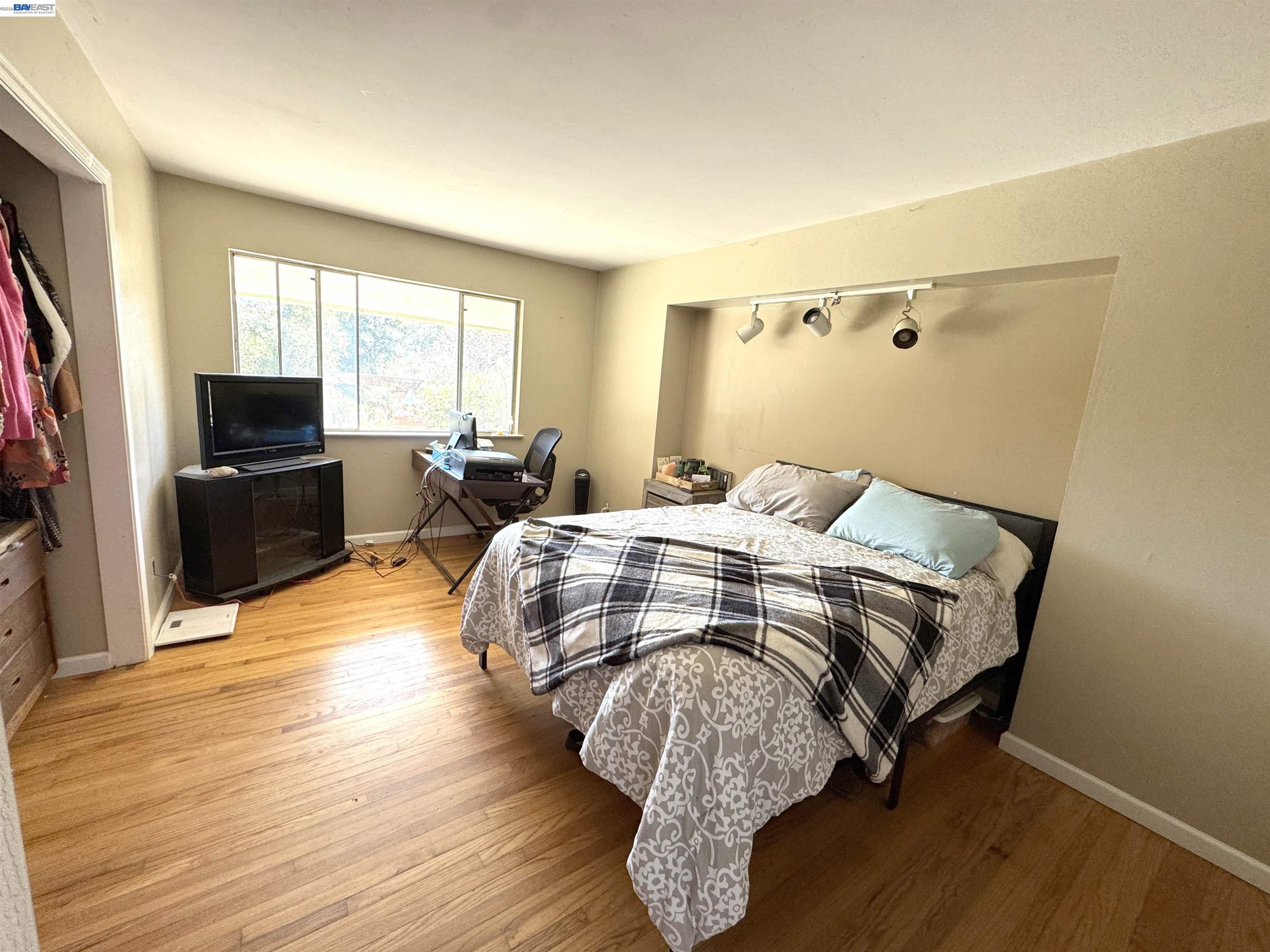 17121 Laurel Road Los Gatos, CA 95033 - Photo 19 of 43 a bedroom with a bed and wooden floor