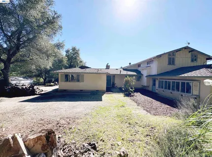 a front view of a house with a yard covered in snow