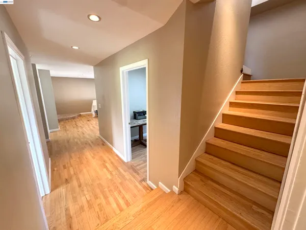 a view of entryway and hall with wooden floor