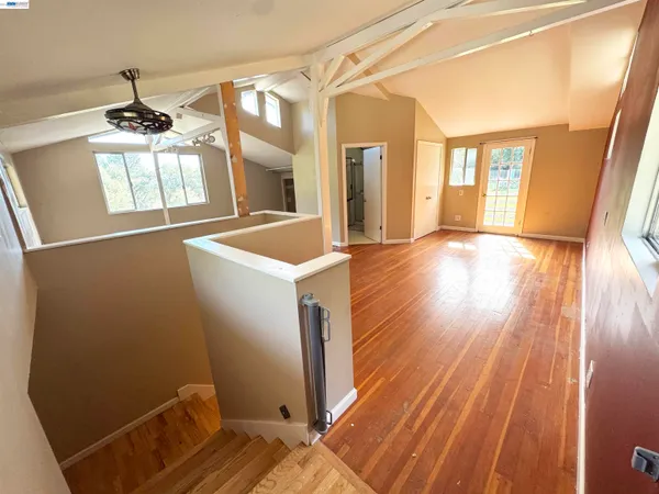 a view of a room with wooden floor and staircase