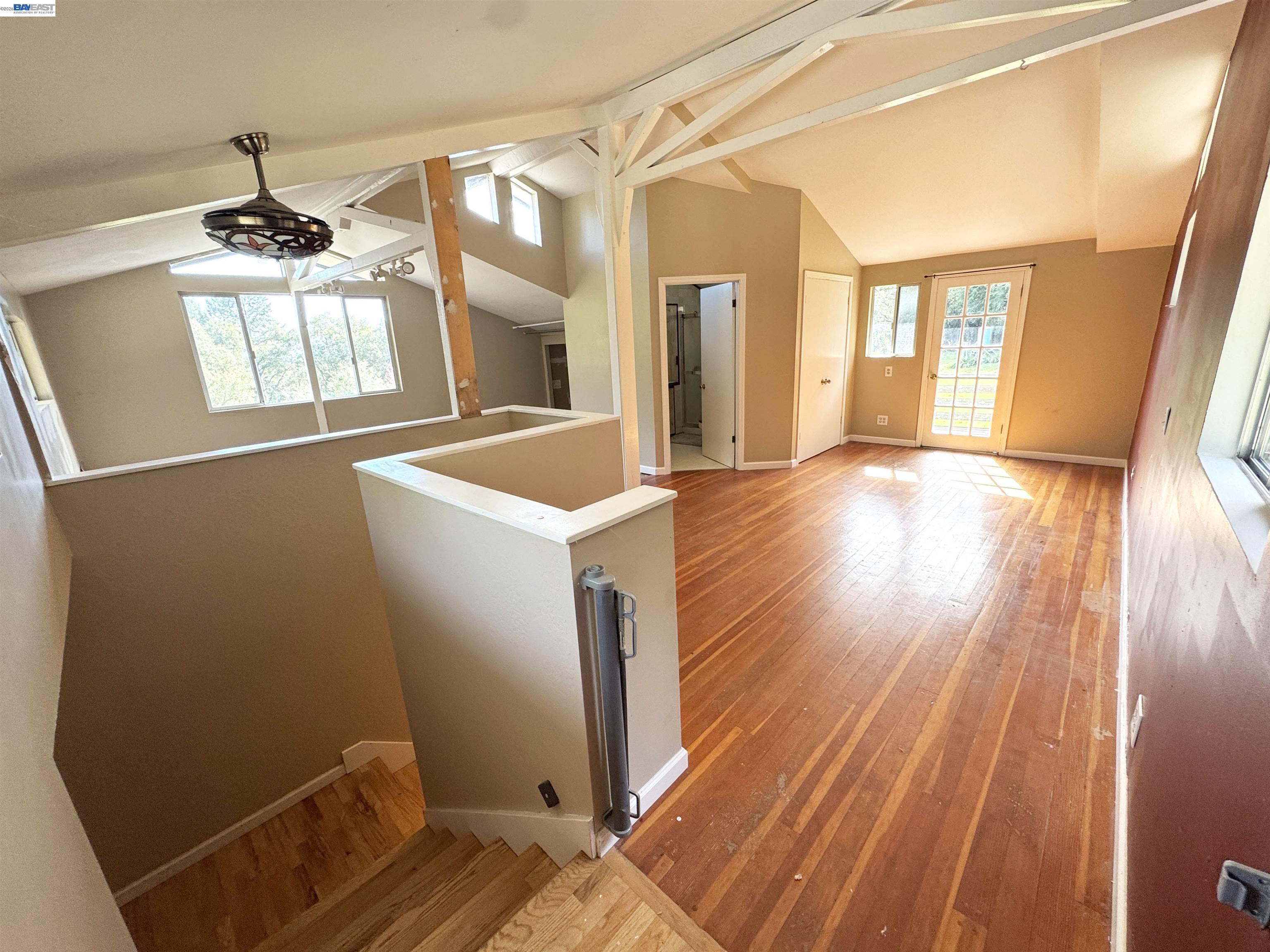 17121 Laurel Road Los Gatos, CA 95033 - Photo 23 of 43 a view of a room with wooden floor and staircase