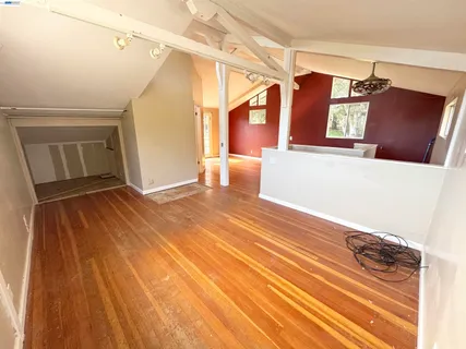 a view of a room with wooden floor