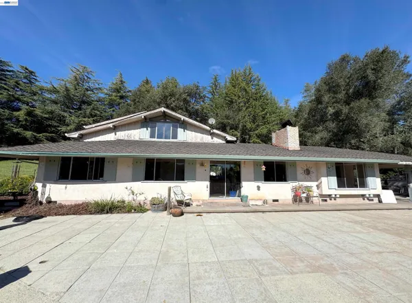 a front view of a house with yard and seating area