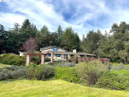 a house with swimming pool in front of it