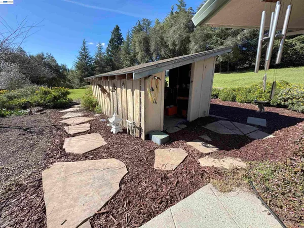 a view of backyard with outdoor seating and green space