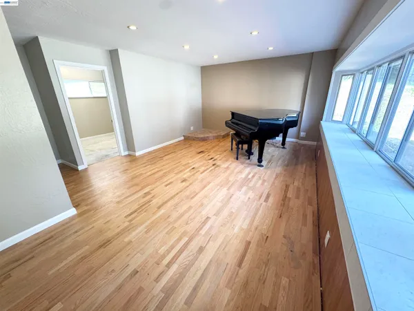 a view of a room with wooden floor and staircase