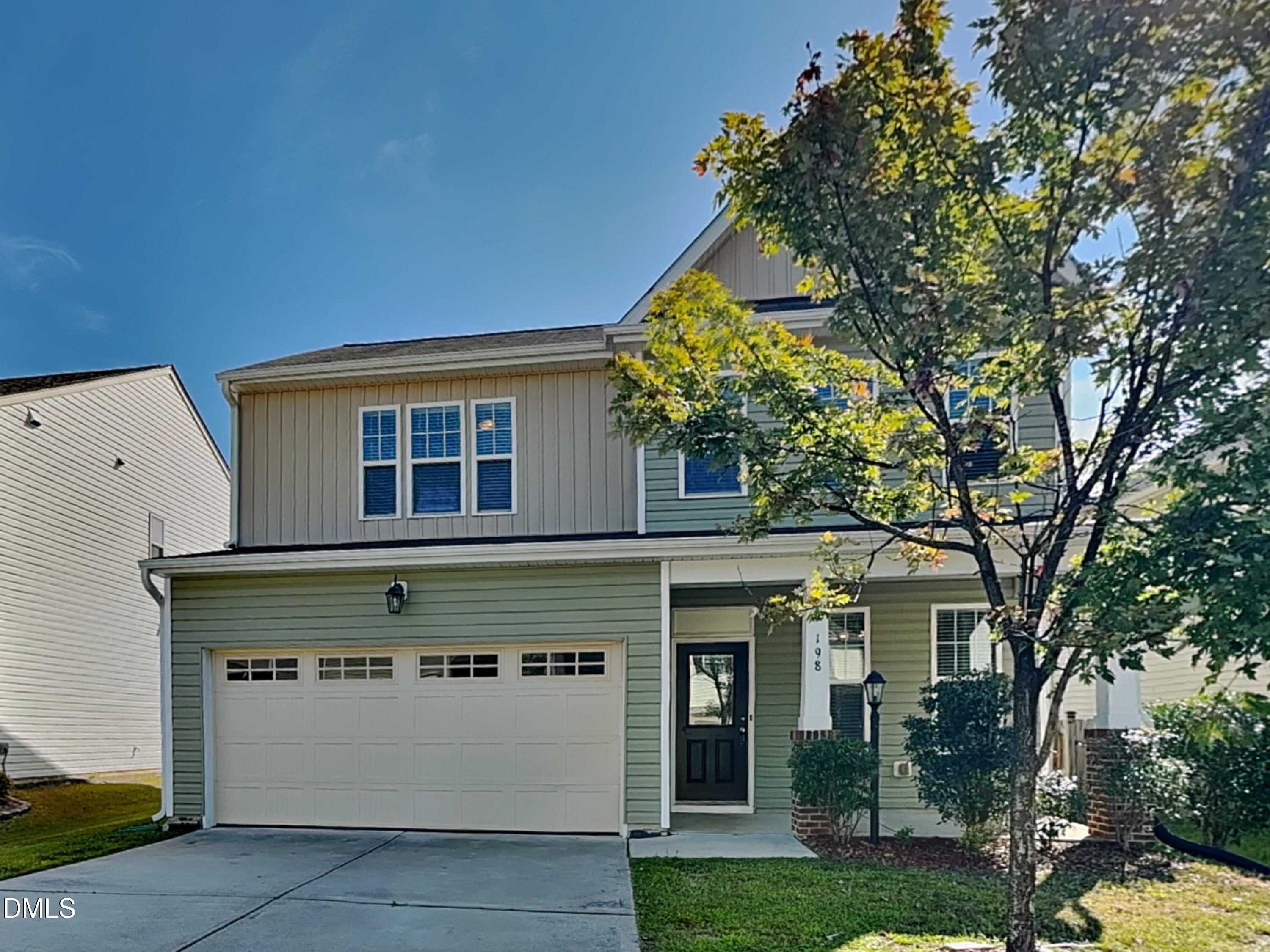 198 Outwater Ridge Drive Garner, NC 27529 - Photo 1 of 22 a front view of a house with a garden