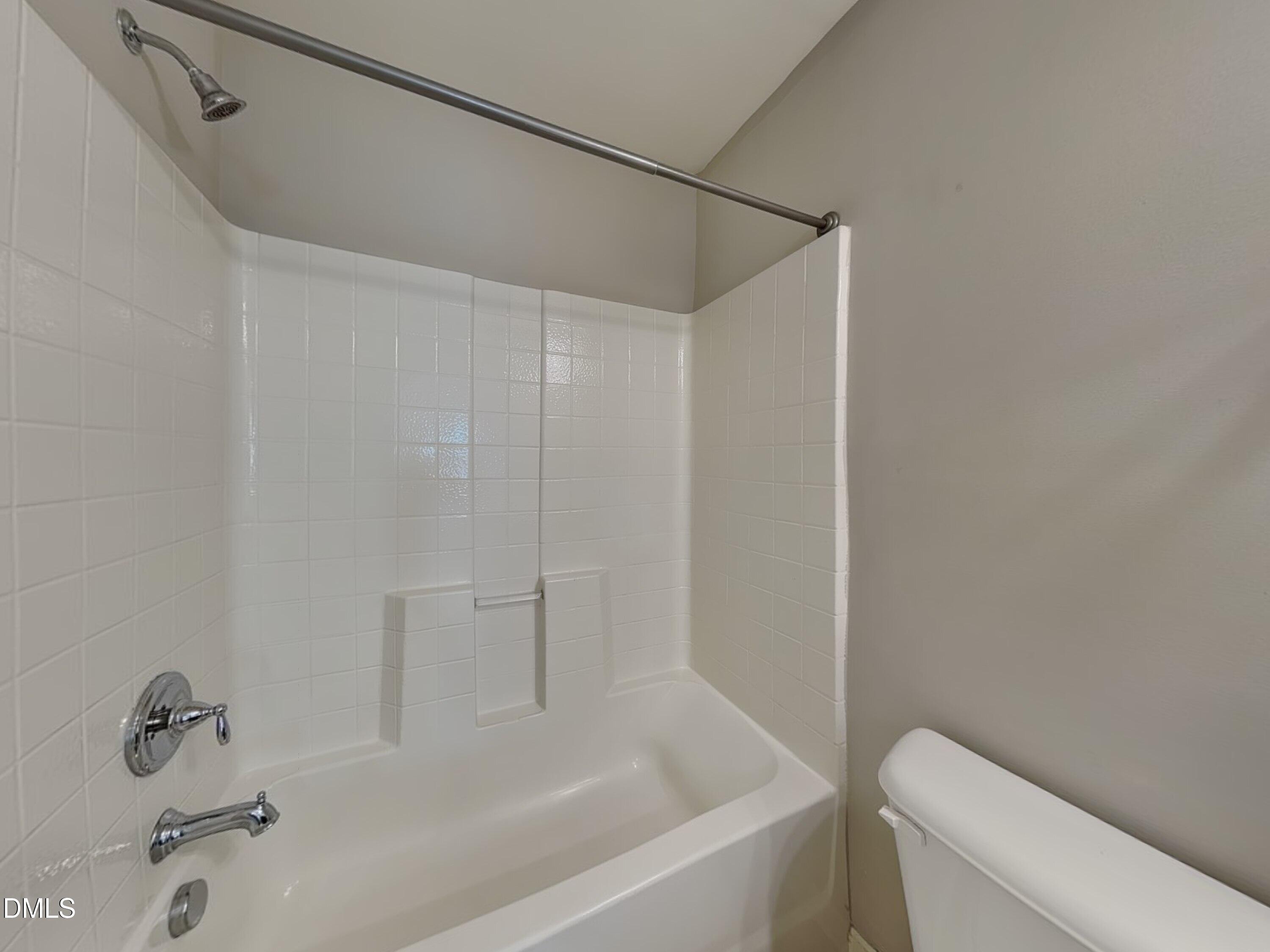 198 Outwater Ridge Drive Garner, NC 27529 - Photo 11 of 22 a bathroom with a bathtub and a toilet