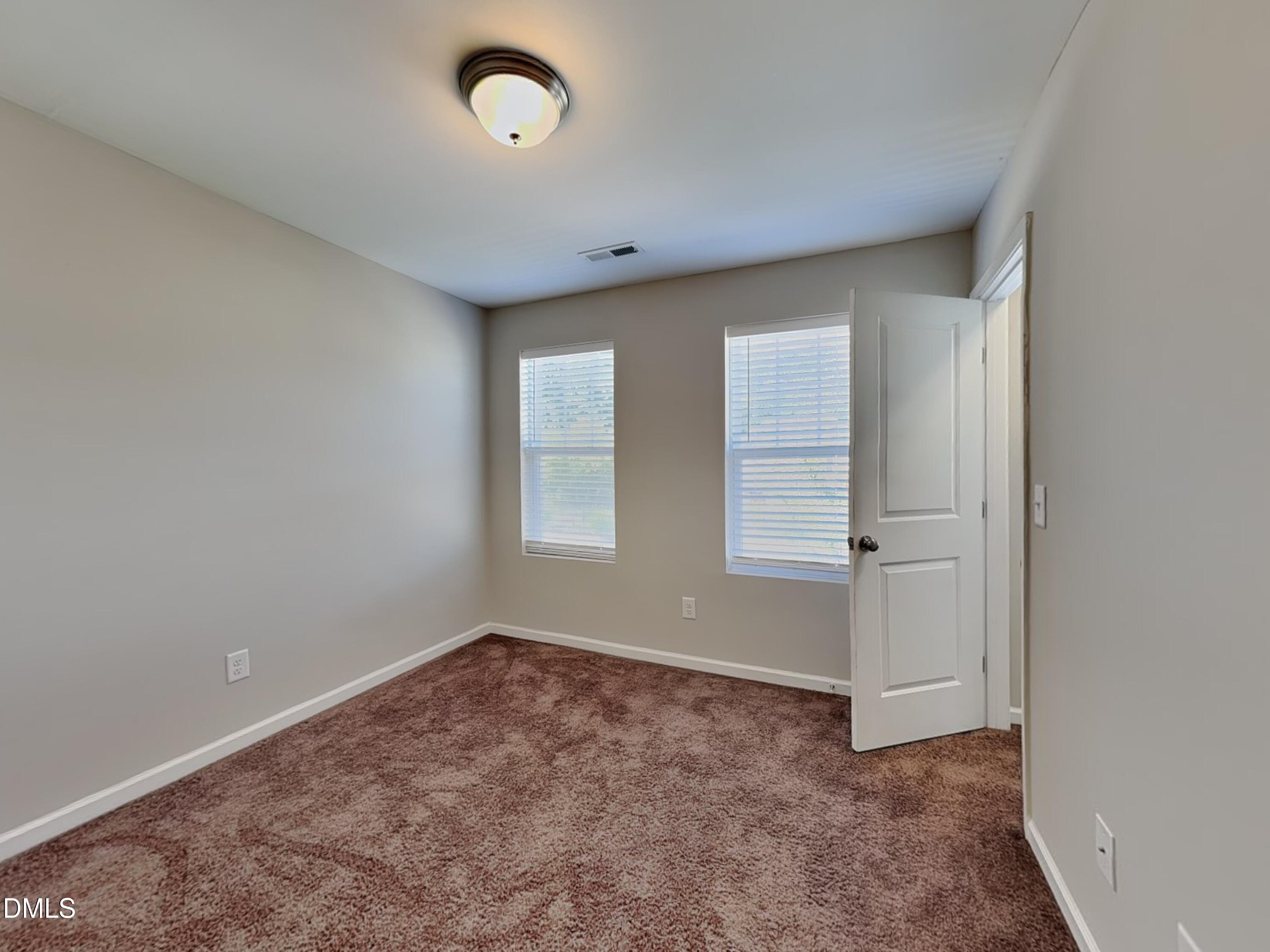198 Outwater Ridge Drive Garner, NC 27529 - Photo 13 of 22 an empty room with windows and closet