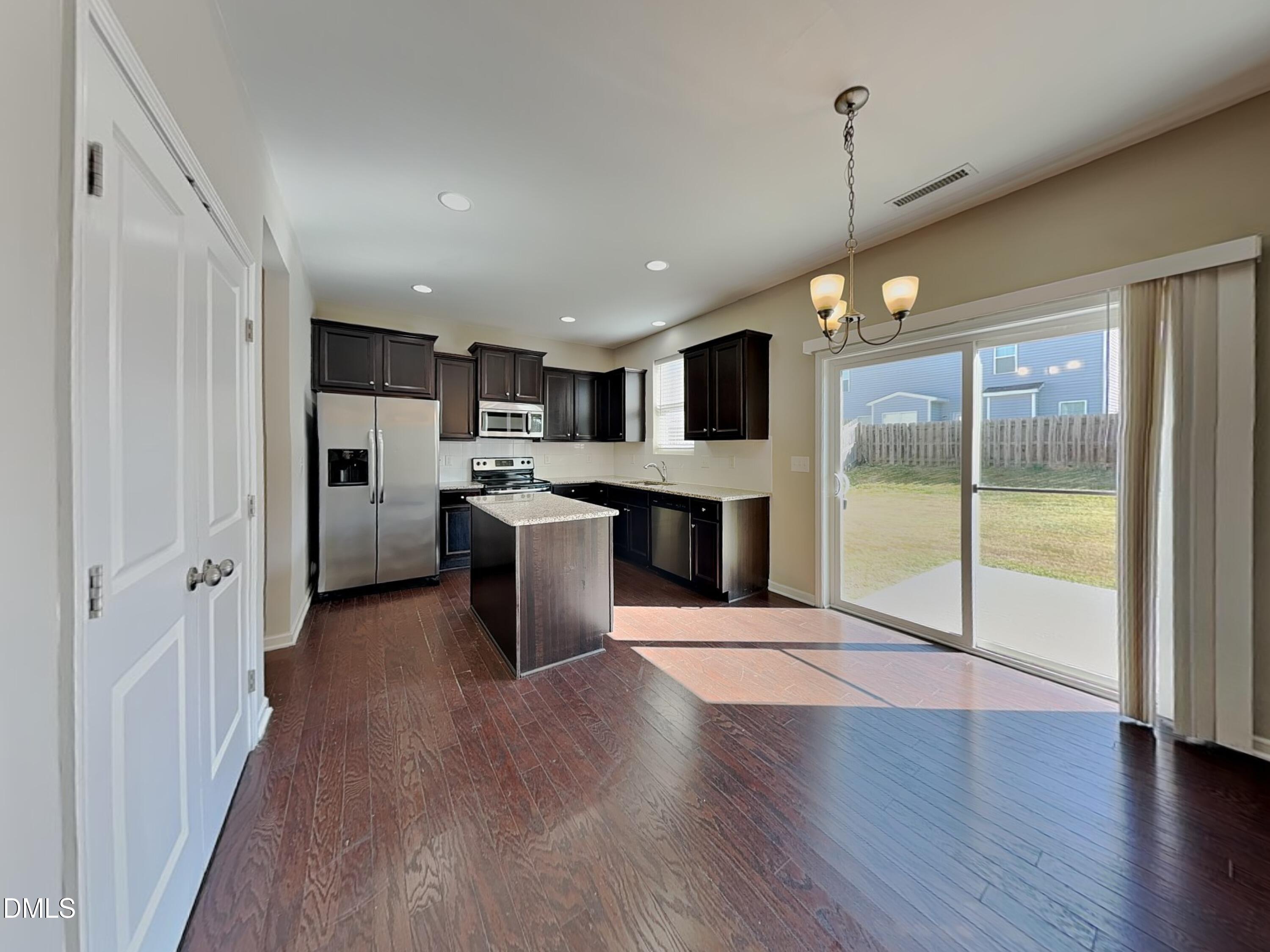 198 Outwater Ridge Drive Garner, NC 27529 - Photo 3 of 22 a view of a kitchen with a sink and a refrigerator