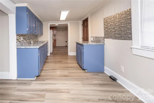 a kitchen with stainless steel appliances granite countertop a stove and a refrigerator