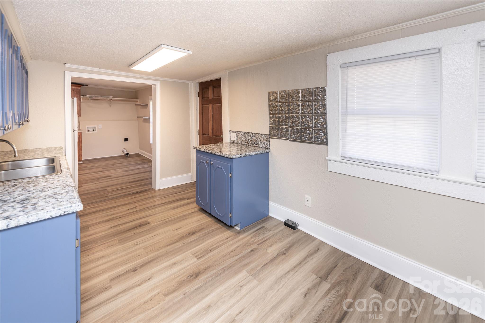 470 South Moose Road Mount Pleasant, NC 28124 - Photo 13 of 37 a living room with hard wood floors and a kitchen